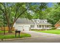 Charming one-story home featuring a well-manicured lawn, two-car garage, and a welcoming front porch at 114 Heritage St, Summerville, SC 29485