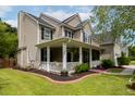 Stunning two-story home with a large front porch, meticulously maintained landscaping, and classic design at 125 Spring Meadows Dr, Summerville, SC 29485