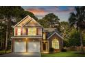 Charming two-story home featuring brick accents, neutral siding, and a well-manicured front lawn at 126 Thousand Oaks Cir, Goose Creek, SC 29445