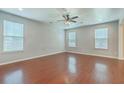 Bright and spacious living room featuring gleaming hardwood floors and large windows at 1350 Wild Goose Trl, Summerville, SC 29483