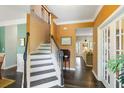 Inviting entryway with hardwood floors, staircase, and views into the adjacent living spaces with lots of natural light at 1417 S Jetties Ct, Mount Pleasant, SC 29466