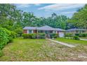 Quaint red brick home with a well-manicured lawn and inviting curb appeal at 1430 Brian Rd, Charleston, SC 29407