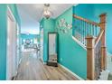 Bright hallway with decorative mirror, wood-look floors, and easy access to living areas at 146 Chaste Tree Cir, Goose Creek, SC 29445
