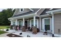 Cozy front porch with rocking chairs and seasonal décor, creating a welcoming entrance at 148 Hidden Hills Rd, Cross, SC 29436