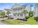 Beautiful two-story home with double porches, lovely landscaping, and a well-manicured lawn in a serene neighborhood at 1485 Bourne Xing, Mount Pleasant, SC 29466