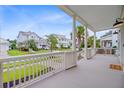 Expansive front porch offering neighborhood views, combining comfort and elegance for outdoor relaxation at 1485 Bourne Xing, Mount Pleasant, SC 29466