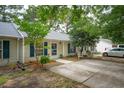 Charming townhouse featuring a well-maintained yard, quaint patio, and blue shutters at 1505 Blaze Ln, Charleston, SC 29412
