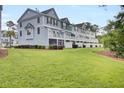 Backyard featuring well-manicured lawn and view of the townhome exterior at 1550 Spring Moss Rd, Mount Pleasant, SC 29466
