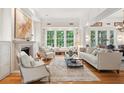 Bright living room features a fireplace, large windows, and comfortable seating, perfect for relaxation and entertaining at 1612 John Fenwick Ln, Johns Island, SC 29455