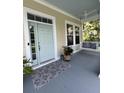 Inviting front porch with a swing, stylish rug, and refreshing blue ceiling, creating a relaxing outdoor space at 1721 Wellstead St, Mount Pleasant, SC 29466