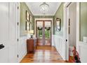 Elegant entryway with hardwood floors, wainscoting, and a stylish chandelier at 1809 Rushland Grove Ln, Johns Island, SC 29455