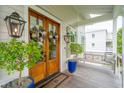 Welcoming entryway with double doors, hanging lanterns, and a cozy porch swing at 1809 Rushland Grove Ln, Johns Island, SC 29455