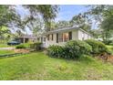 Charming single-story home with mature landscaping and a well-kept lawn at 1909 Swift Ave, Charleston, SC 29407