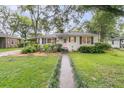 Inviting single-story home with a well-manicured lawn and a quaint front walkway at 1909 Swift Ave, Charleston, SC 29407