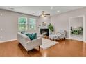 Comfortable living room showcasing wood floors, a fireplace, and bright windows with backyard view at 241 Clayburne Dr, Goose Creek, SC 29445