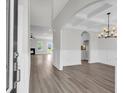 Open living room and dining area featuring hardwood floors, a fireplace, and elegant trimwork at 2477 Sawlog Ln, Summerville, SC 29486