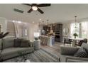 Inviting open-concept living room and kitchen with modern furnishings, wood floors, and bright natural light at 2477 Sawlog Ln, Summerville, SC 29486