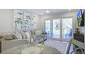 Cozy living room with a comfortable sofa, dining table, and sliding glass doors to the balcony at 2909 Atrium Villa, 9, Seabrook Island, SC 29455