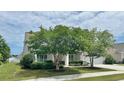 Beautiful home with lush landscaping, mature trees, and well-maintained lawn at 310 Waterlily Way, Summerville, SC 29486