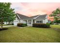 Inviting single Gathering home features a pristine front yard with manicured landscaping and a welcoming entrance at 361 Waterlily Way, Summerville, SC 29486
