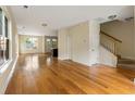 Spacious living room with hardwood floors, and staircase leading to upper level at 5104 E Liberty Park Cir, North Charleston, SC 29405