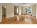 Open-concept living room with hardwood floors and a view to the front yard at 5104 E Liberty Park Cir, North Charleston, SC 29405