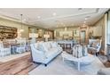 Open-concept living room, dining area, and kitchen with hardwood floors and neutral decor at 593 Marsh Cove Cir, Summerville, SC 29486