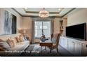 Comfortable home office with large window, built-in shelving and tray ceiling at 629 Marsh Cove Cir, Summerville, SC 29486