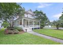 Beautiful two-story home featuring a wide front porch and lush landscaping at 701 Hibbens Grant Blvd, Mount Pleasant, SC 29464