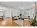 Bright living room featuring hardwood floors, large windows, and stylish furnishings at 701 Hibbens Grant Blvd, Mount Pleasant, SC 29464