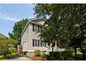 Two-story home with vinyl siding, complemented by manicured landscaping and a side driveway at 815 Harbor Pl Dr, Charleston, SC 29412