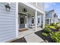 Inviting front porch with stylish decor and ample seating at 1017 Saltwater Cir, Johns Island, SC 29455