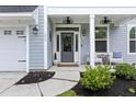 Welcoming front porch with cozy seating and decorative accents at 1017 Saltwater Cir, Johns Island, SC 29455