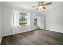 Bright bedroom features new floors, a ceiling fan, a window, and a door to the backyard at 102 Berkshire Ct, Goose Creek, SC 29445