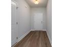 Inviting hallway featuring wood-look flooring and fresh, neutral paint throughout at 122 Royal Cainhoy Way, Huger, SC 29450