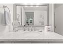 Bright bathroom featuring a modern vanity with a marble countertop, ample lighting, and stylish accessories at 1326 Sea Elder Dr, Kiawah Island, SC 29455