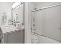 Modern bathroom featuring a sleek vanity with marble countertop and a shower-over-tub with sliding glass doors at 1326 Sea Elder Dr, Kiawah Island, SC 29455