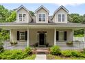 Inviting two-story home featuring a classic front porch and beautiful curb appeal at 1431 Whispering Oak Trl, Mount Pleasant, SC 29466