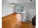 Inviting entryway with hardwood floors, light fixture, and staircase at 1481 Woodview Ln, Charleston, SC 29412