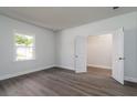 Bright bedroom with hardwood floors, white walls, double doors leading to a closet, and natural light at 153 Royal Cainhoy Way, Huger, SC 29450