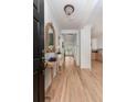 Welcoming foyer with wood floors, shiplap walls, and views into the connected living spaces at 1532 Sea Palms Cres, Mount Pleasant, SC 29464