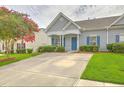 Charming gray home with blue shutters and a well-manicured front yard creates a welcoming curb appeal at 159 Townsend Way, Summerville, SC 29483