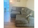 Comfortable living room with a large sectional sofa and ottoman on hardwood floors at 160 Lancashire Rd, Summerville, SC 29486