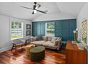 Bright living room with modern teal accents, a ceiling fan, and hardwood floors at 1940 Orangeburg St, North Charleston, SC 29405
