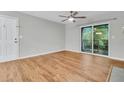 Bright living room showcasing wood floors, neutral walls, and sliding glass door to balcony at 2011 N Hwy 17 # 2200H, Mount Pleasant, SC 29466