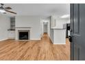Inviting living room featuring a fireplace, hardwood floors, and open layout to the kitchen at 2011 N Hwy 17 # 2200H, Mount Pleasant, SC 29466