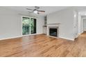 Living room with a cozy fireplace, sliding glass door to balcony, and an adjacent bar area at 2011 N Hwy 17 # 2200H, Mount Pleasant, SC 29466