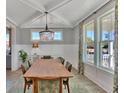Elegant dining room featuring large windows, decorative chandelier, and seating for eight at 2038 Sea Water Dr, James Island, SC 29412