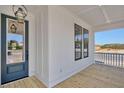 Spacious porch with railing, wood decking, and an exterior entry door at 2038 Sea Water Dr, James Island, SC 29412