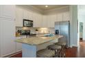 Modern kitchen featuring stainless steel appliances, granite countertops, and ample cabinet space at 204 Michigan Ave # C-5 - 11, Folly Beach, SC 29439